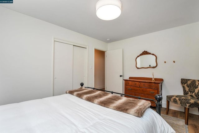 bedroom with hardwood / wood-style floors and a closet