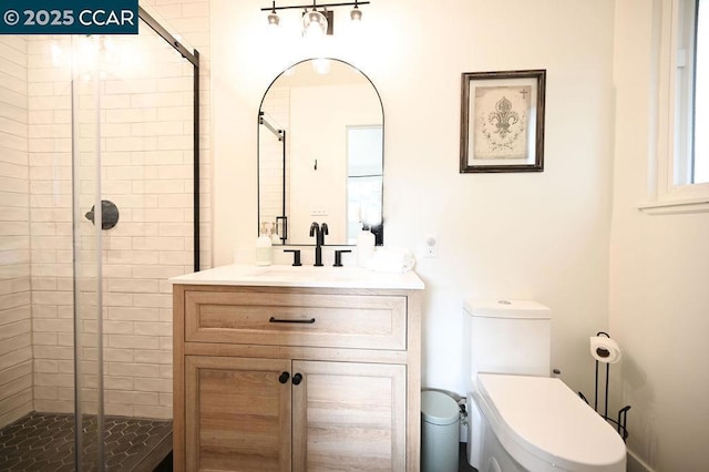 bathroom with a shower with door, vanity, and toilet