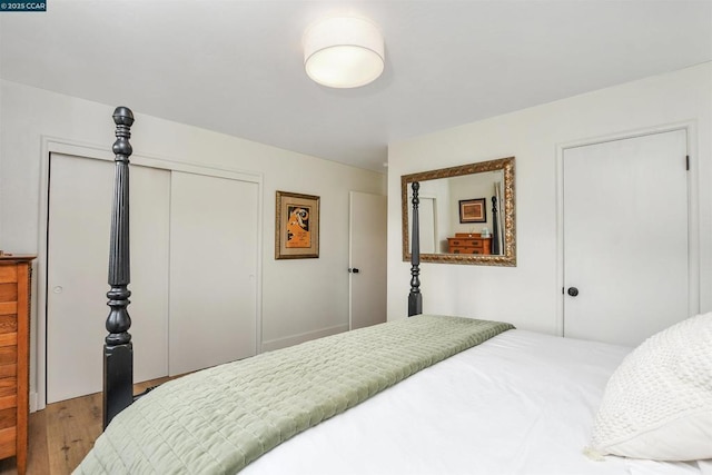 bedroom featuring hardwood / wood-style flooring and a closet