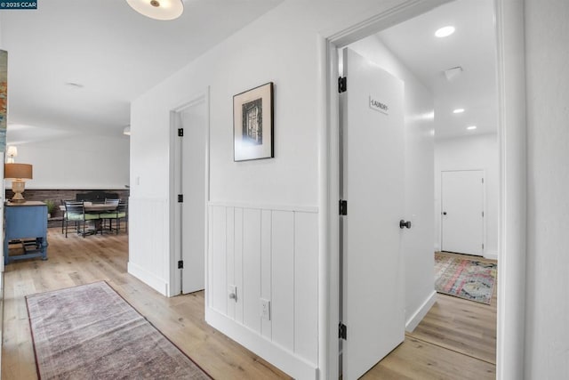 hallway with light hardwood / wood-style floors