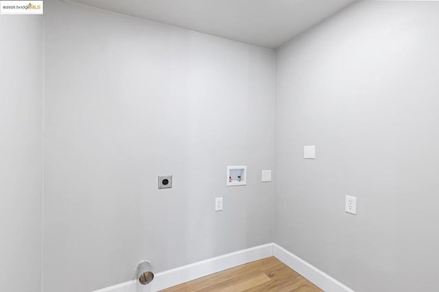 laundry area with hardwood / wood-style flooring, hookup for a washing machine, and hookup for an electric dryer