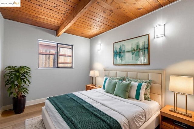 bedroom with light wood-type flooring, wooden ceiling, and beamed ceiling