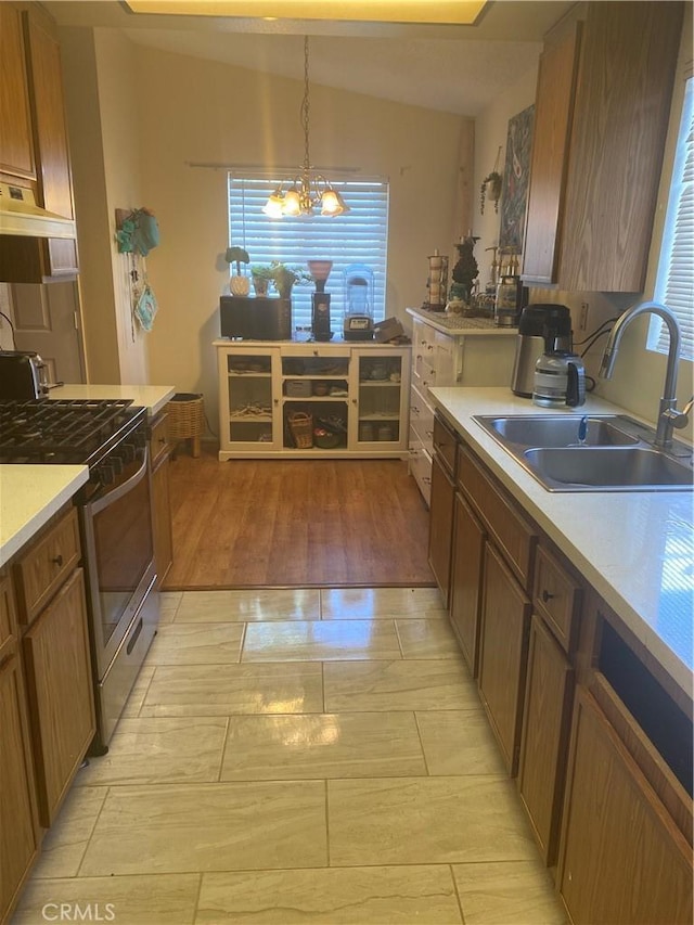 kitchen with sink, decorative light fixtures, plenty of natural light, and stainless steel range with gas stovetop