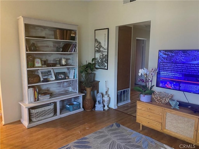 sitting room with wood finished floors and visible vents