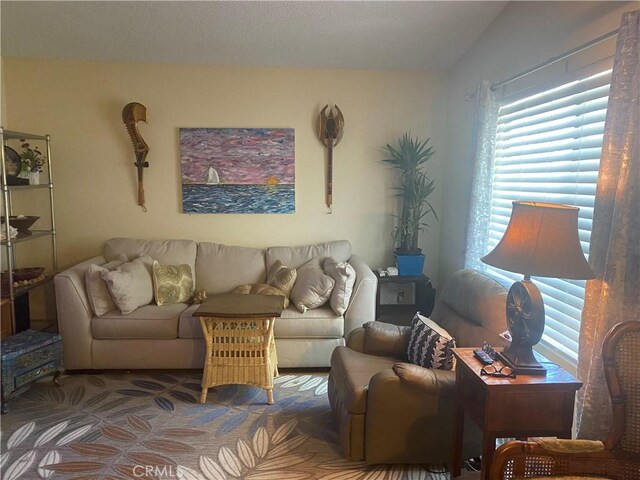 carpeted living room featuring vaulted ceiling