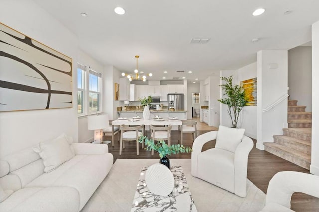 living room with a chandelier and light hardwood / wood-style floors