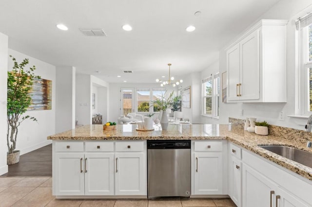 kitchen with dishwasher, sink, kitchen peninsula, and white cabinets