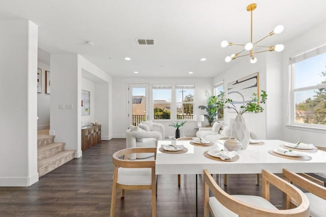 dining space with an inviting chandelier and dark hardwood / wood-style floors