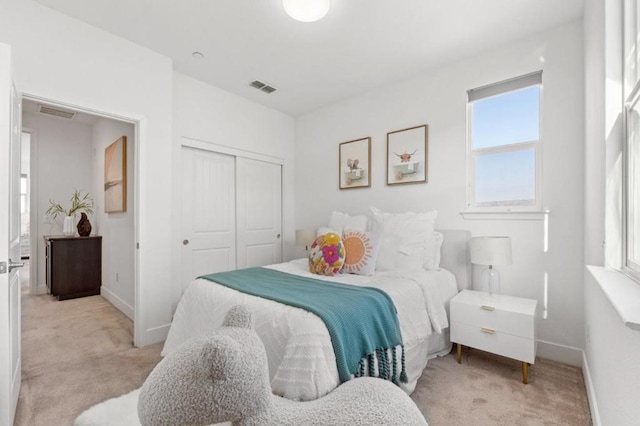 carpeted bedroom featuring a closet