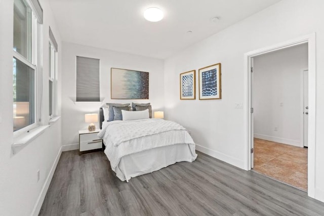 bedroom with dark wood-type flooring