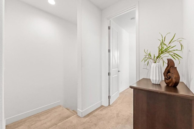 hallway with light colored carpet