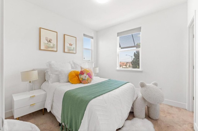 bedroom featuring light colored carpet