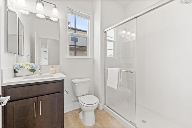 bathroom with tile patterned flooring, walk in shower, vanity, and toilet