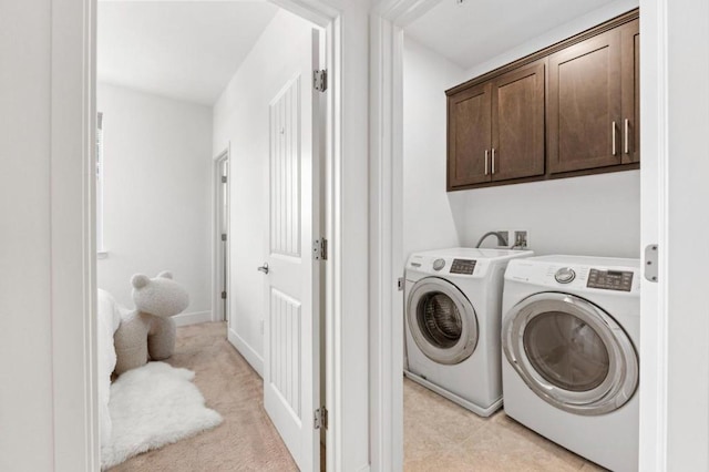 laundry room with cabinets and washer and dryer