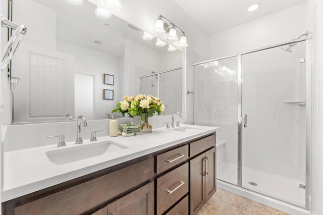 bathroom with tile patterned flooring, vanity, and a shower with shower door