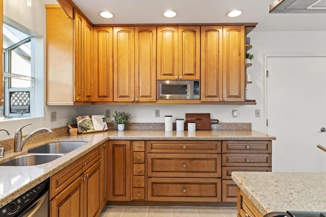 kitchen with sink, light tile patterned floors, appliances with stainless steel finishes, light stone countertops, and exhaust hood