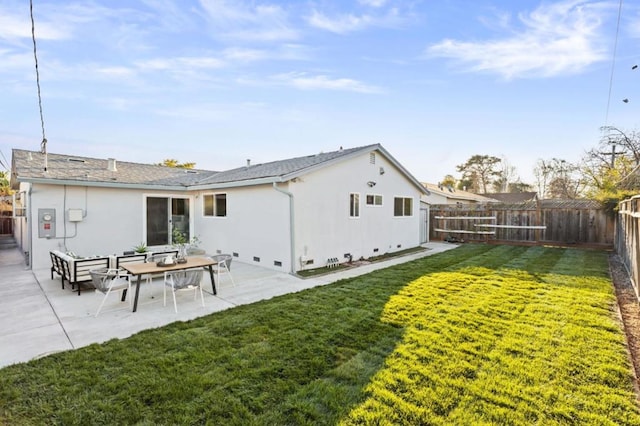 rear view of house featuring a patio area and a lawn