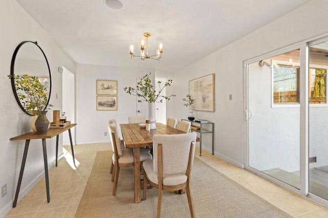 tiled dining room with an inviting chandelier