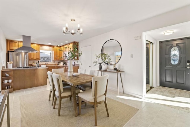 dining space featuring light tile patterned floors and a chandelier