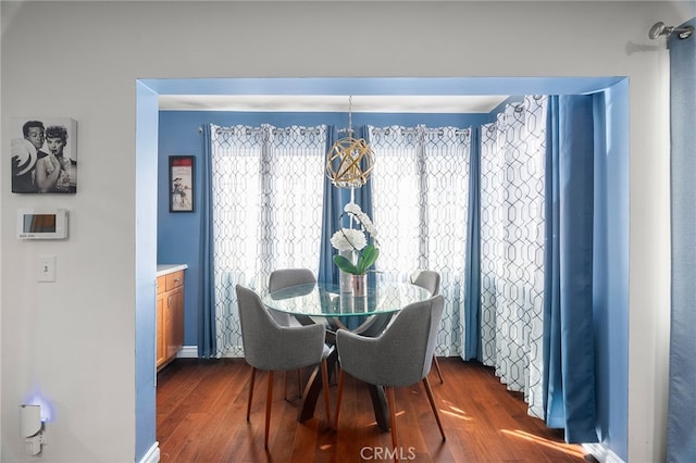 dining area with dark hardwood / wood-style floors