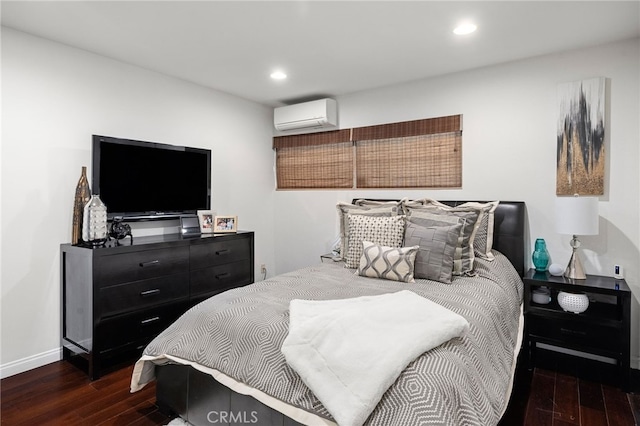 bedroom featuring dark wood-type flooring and a wall mounted AC