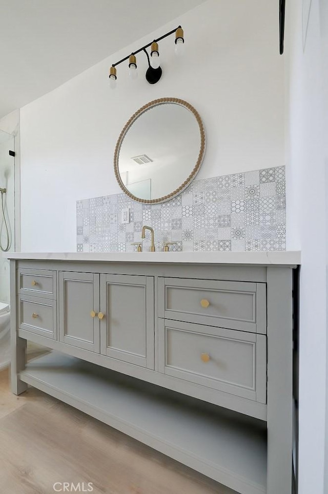 bathroom with toilet, vanity, and hardwood / wood-style flooring