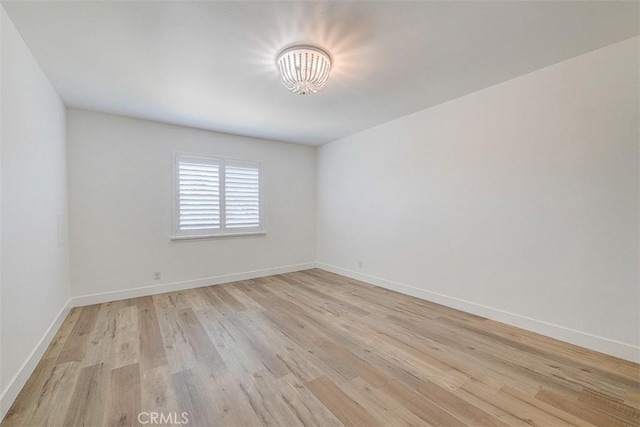 spare room with light wood-type flooring