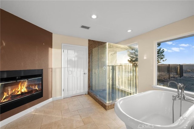 bathroom with a large fireplace and plus walk in shower