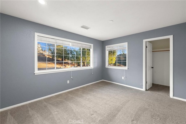 unfurnished bedroom with carpet floors and a closet