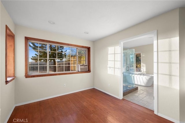 empty room with hardwood / wood-style flooring