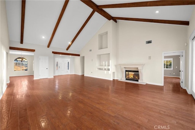 unfurnished living room featuring beamed ceiling, a chandelier, high vaulted ceiling, and hardwood / wood-style floors