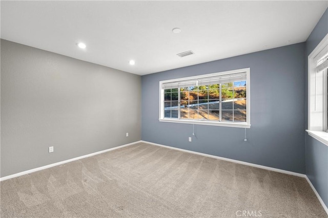 carpeted empty room featuring a healthy amount of sunlight