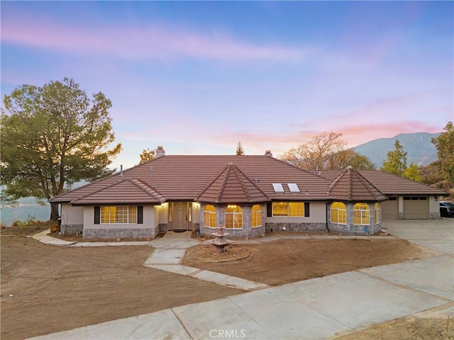 view of front of house with a mountain view and a garage