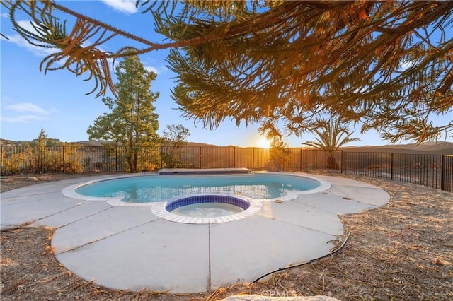 view of swimming pool with an in ground hot tub