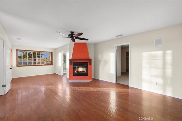 unfurnished living room featuring hardwood / wood-style flooring, a fireplace, and ceiling fan