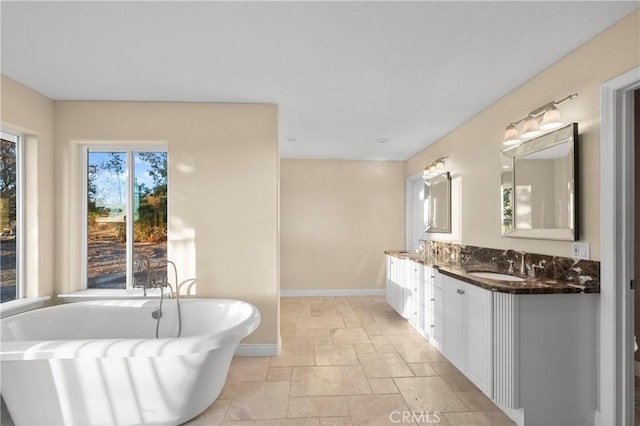 bathroom with vanity and a bath