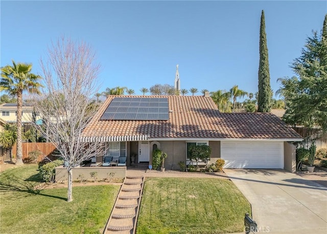 ranch-style house with a front yard, a garage, and solar panels