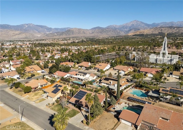 birds eye view of property with a mountain view