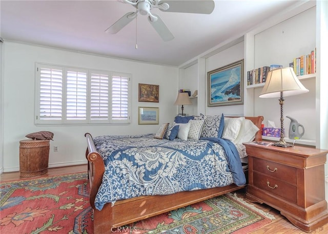 bedroom with ceiling fan and wood-type flooring