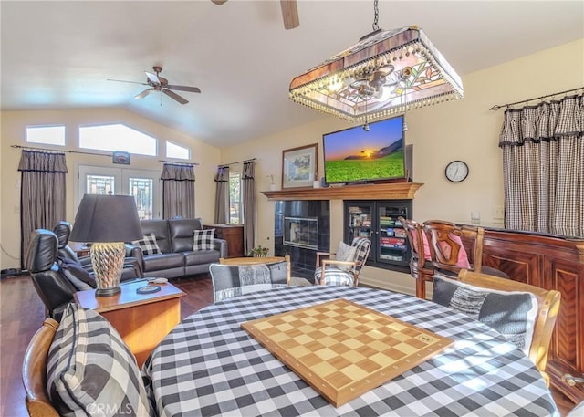 living room with ceiling fan, dark hardwood / wood-style flooring, and lofted ceiling