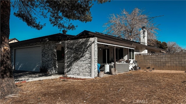 view of side of home featuring a garage