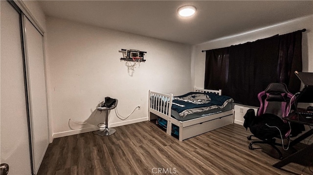 bedroom featuring a closet and dark hardwood / wood-style floors