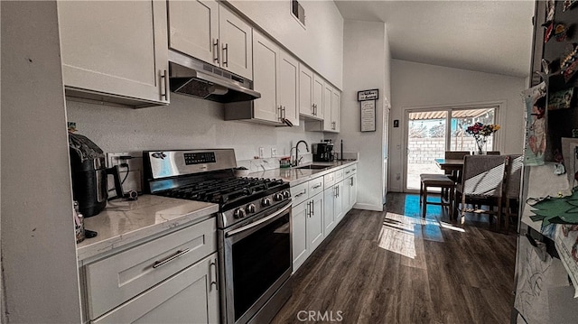 kitchen with sink, white cabinetry, vaulted ceiling, and stainless steel range with gas stovetop