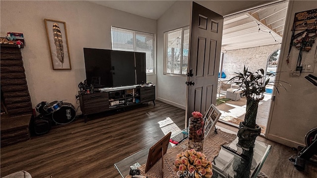 living room with dark wood-type flooring and vaulted ceiling