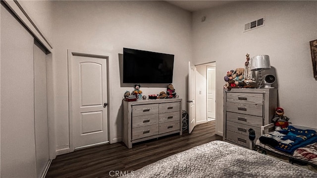 bedroom with a closet and dark hardwood / wood-style floors