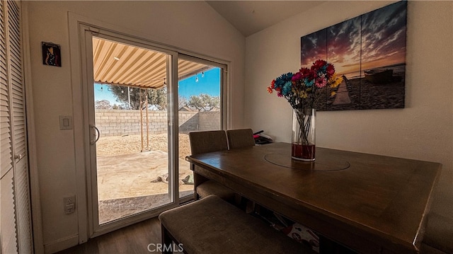 dining space featuring lofted ceiling and hardwood / wood-style flooring