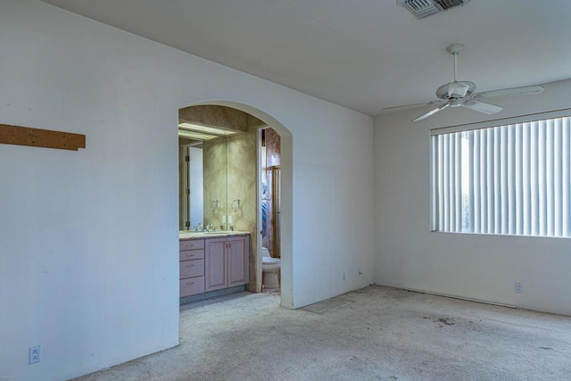 carpeted spare room with sink and ceiling fan