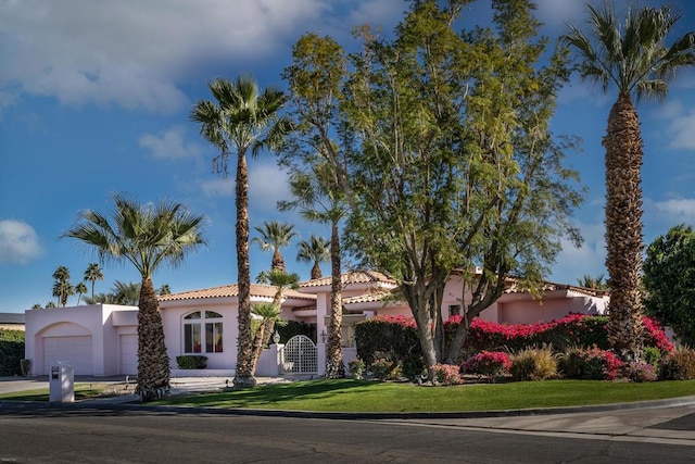 mediterranean / spanish house featuring a garage