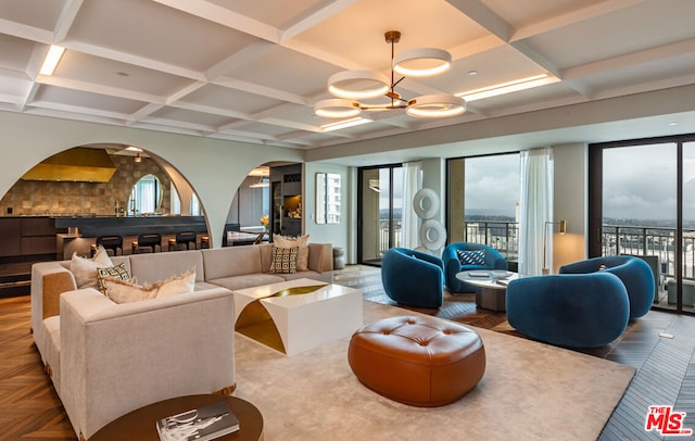 living room with an inviting chandelier, parquet floors, and expansive windows