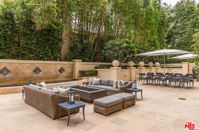 view of patio / terrace featuring an outdoor living space with a fire pit